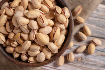 pistachio nuts on wooden table