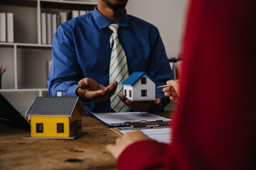 Real estate broker agent presenting and consult to customer to decision making sign insurance form...