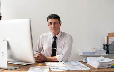 Fototapeta premium Business accountant bookkeeper in office looking at documents and working with laptop.