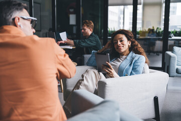Group of diverse colleagues with devices in workplace