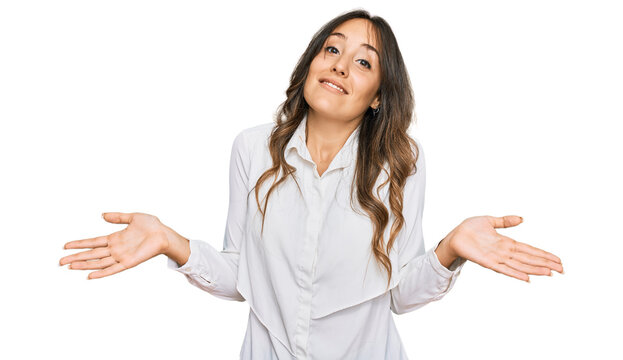 Young brunette woman wearing casual clothes clueless and confused expression with arms and hands raised. doubt concept.