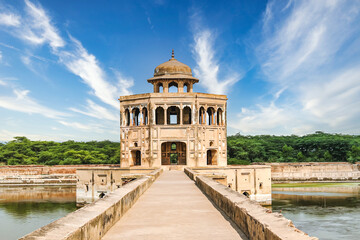 The exquisite minaret and tranquil lake at Hiran Minar, a UNESCO World Heritage Site, in...