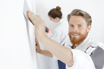 young builder pastering a wall