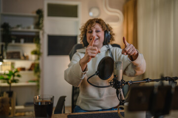 Fototapeta premium woman shooting or streaming video podcast or vlogg blogger at studio