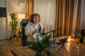 woman shooting or streaming video podcast or vlogg blogger at studio