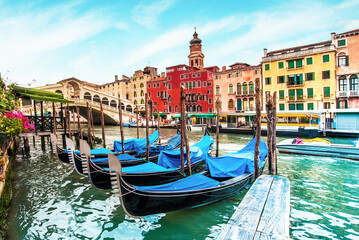 Fototapeta na wymiar magical landscape with gondolas and boats on the Grand Canal in Venice, Italy. popular tourist attraction. Wonderful exciting places.