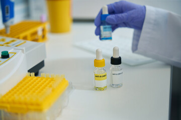 Laboratory assistant holds a reagent for determining the blood type