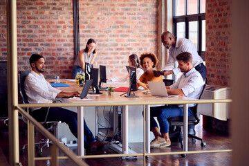 Business Team Working Together In Busy Multi-Cultural Office 