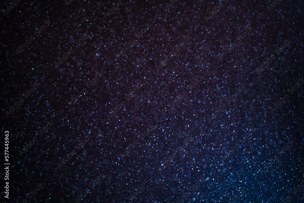 Canvas Prints organic dust particles floating on a colorful light beam on black background. glittering sparkling f