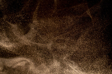 Dust particles cloud generating abstract shape on black background with copy space for text, web,...