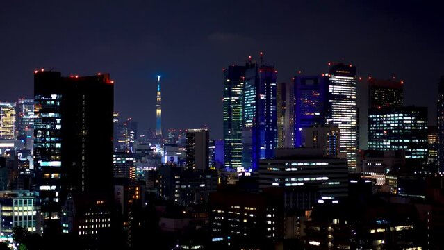 TOKYO - OCT 1st, 2022: Skyscrapers at night in Minato, Tokyo, Japan with a view of the Sky tree