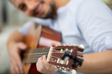 guitar in the hands of a smiling male musician