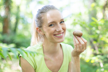 happy young housewife holding mushroom