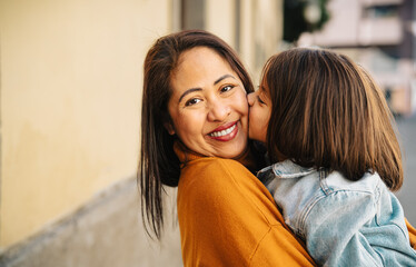 Happy southeast Asian mother with her daughter having tender moments in the city center - Lovely...