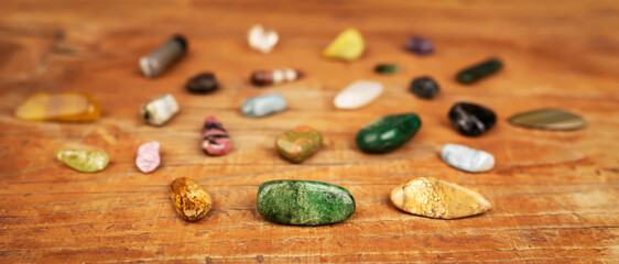 Colorful mineral stones, gemstones on wooden background. Alternative therapy, crystal healing banner.