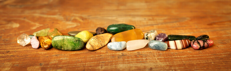 Colorful mineral stones, gemstones on wooden background. Alternative therapy, crystal healing...