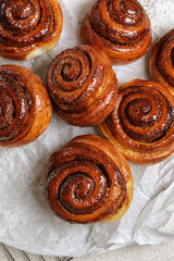 Freshly baked homemade Cinnamon rolls or Cinnamon buns on baking paper