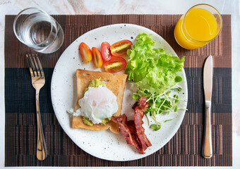 ix dish breakfast salad with fried egg, eggs Benedict, egg burrito, juice, toasted muffins, ham, poached eggs, and delicious buttery hollandaise sauce with fresh salad.