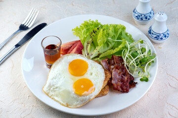 ix dish breakfast salad with fried egg, eggs Benedict, egg burrito, juice, toasted muffins, ham, poached eggs, and delicious buttery hollandaise sauce with fresh salad.