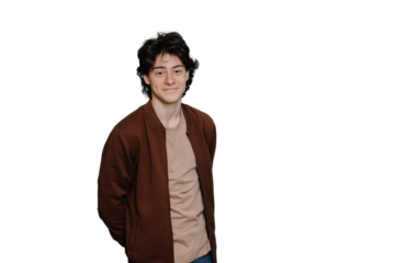 Young handsome caucasian boy in casual standing against transparent background. Cheerful Italian brunet guy looks at camera. Mockup, happy people. Satisfied student entered university. Education.
