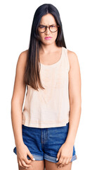 Fototapeta premium Young beautiful caucasian woman wearing casual clothes and glasses skeptic and nervous, frowning upset because of problem. negative person.