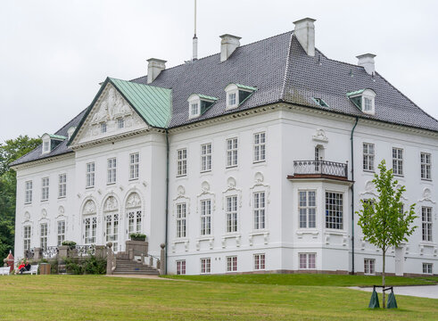 The exterior of the Royal Marselisborg Palace, People visit the garden around the castle
