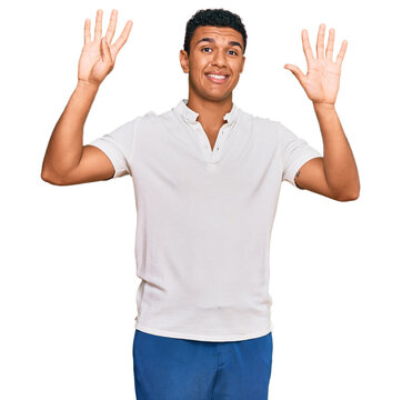 Young arab man wearing casual clothes showing and pointing up with fingers number nine while smiling confident and happy.