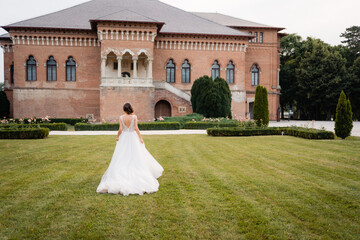 Fototapeta premium bride and groom walking in the park
