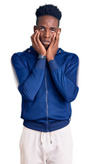 Young african american man wearing sportswear tired hands covering face, depression and sadness, upset and irritated for problem