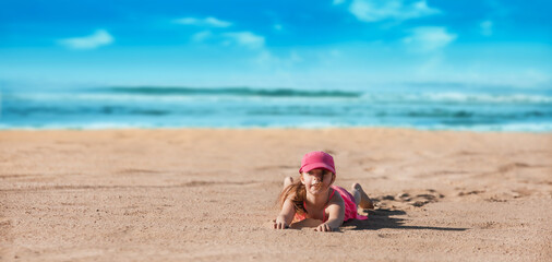 little girl playing on the beach on vacation