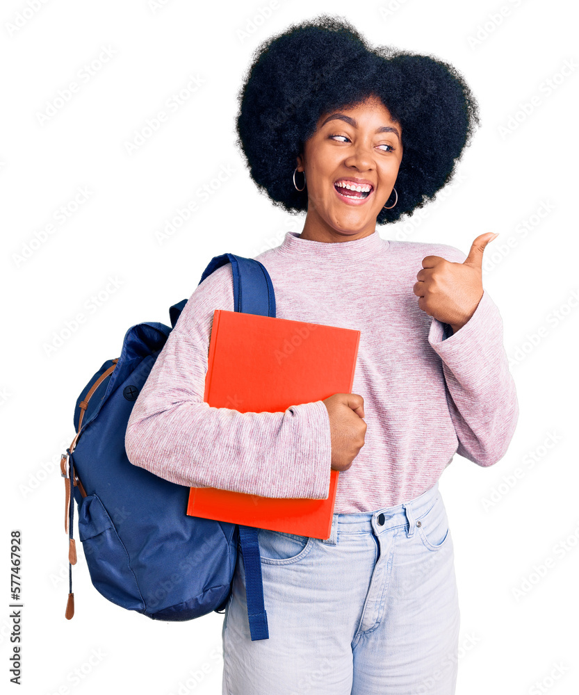 Poster young african american girl wearing student backpack holding book pointing thumb up to the side smil