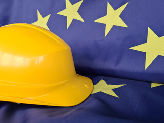 Yellow hard hat and European Union flag. General Confederation of Builders' Unions in Europe