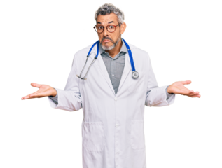 Middle age grey-haired man wearing doctor uniform and stethoscope clueless and confused expression with arms and hands raised. doubt concept.