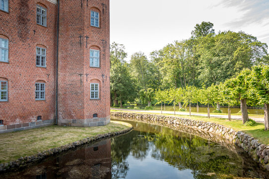 Auning, denmark - 19 June 2021: Gammel Estrup Castle from the 14th century, The castle is surrounded by beautiful nature, trees and lakes and moat