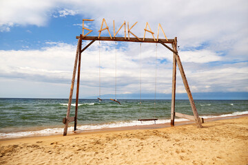 Wooden swing on the beach of Lake Baikal. Barguzin Bay. The Republic of Buryatia. 