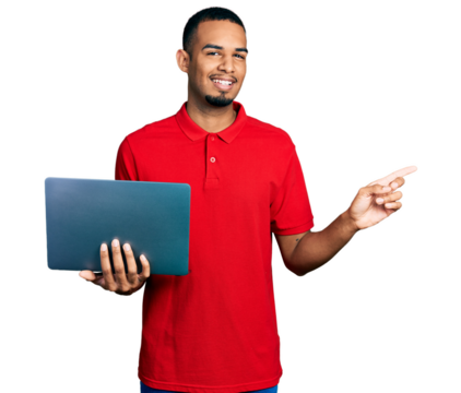 Young african american man working using computer laptop smiling happy pointing with hand and finger to the side - Powered by Adobe