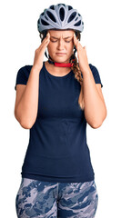 Beautiful caucasian woman wearing bike helmet with hand on head for pain in head because stress. suffering migraine.