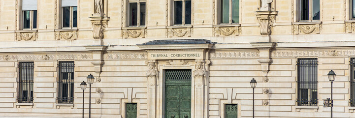 Fototapeta na wymiar Entrance door and name engraved on the former Paris Criminal Court building on the Quai des Orfevres in Paris, France