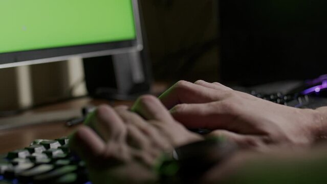 person typing on keyboard, hands only, checking phone, green screen