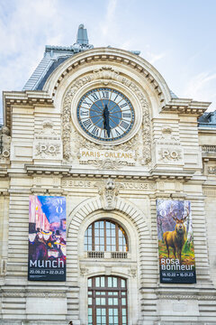 Munch and Rosa Bonheur exhibitions posters and facade of the Orsay museum with view on the giant clock in Paris, France