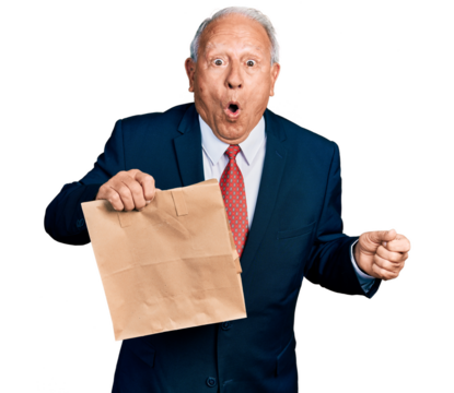 Senior business man with grey hair holding take away paper bag scared and amazed with open mouth for surprise, disbelief face - Powered by Adobe