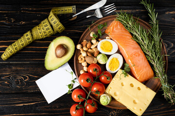 a set of low-carb keto diet products. Fork and knife in measuring tape.