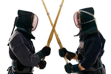 Two men, professional kendo fighter, athletes in black uniform training, crossing swords against white studio background. Concept of martial arts, sport, Japanese culture, action and motion