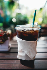 Iced Americano coffee on wood table