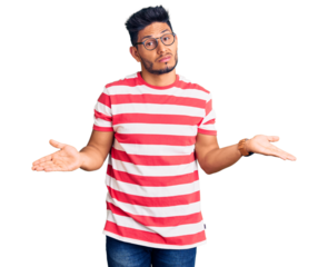 Handsome latin american young man wearing casual clothes and glasses clueless and confused with open arms, no idea concept.