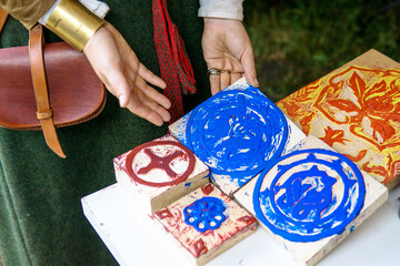 Wooden stamps for decorating fabrics with floral motifs. Wooden textile stamp. Floral hand carved motif. Woodblock printing on textiles. Medieval historical wooden printing stamp or block.