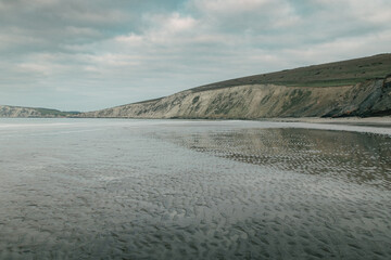 A beautiful sandy beach on an overcast day