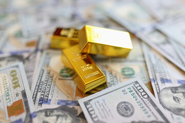 Stack small golden ingots on pots of money cash