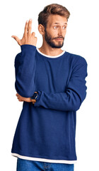 Handsome blond man with beard wearing casual sweater shooting and killing oneself pointing hand and fingers to head like gun, suicide gesture.