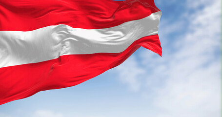 Naklejka na ściany i meble The national flag of Austria waving on a clear day